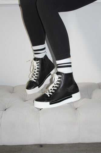 black high tops wiht white laces and embroidered wing detail in black with a white sole